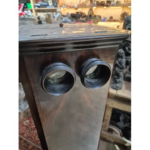 425 - A Victorian walnut floor standing stereoscopic viewer, partially filled with slides, height 121cm.