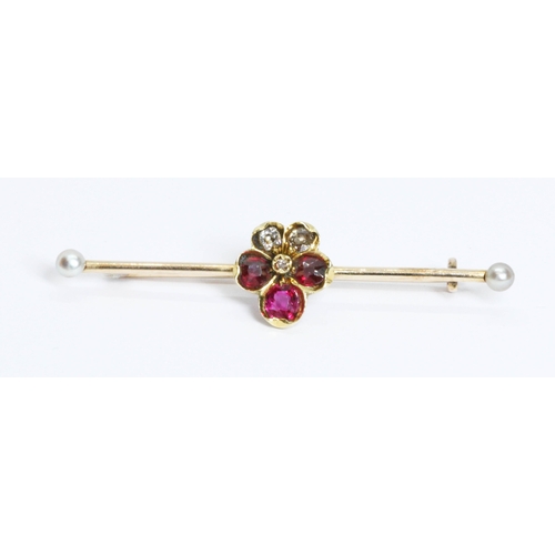 169 - An antique ruby, diamond and seed pearl bar brooch, the central cluster formed as a five leaf clover... 