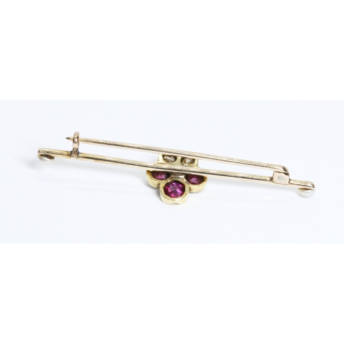 169 - An antique ruby, diamond and seed pearl bar brooch, the central cluster formed as a five leaf clover... 