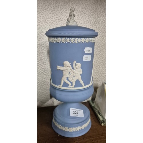 327 - A Wedgwood blue Jasperware 'Blind Man's Buff' urn vase with lid.