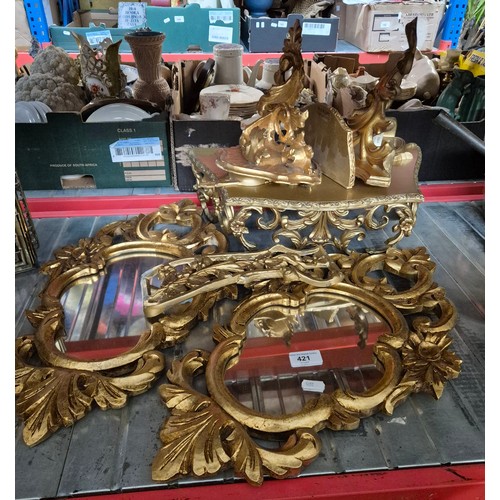 421 - A selection of gilt painted wood framed mirrors together with wall fitments.