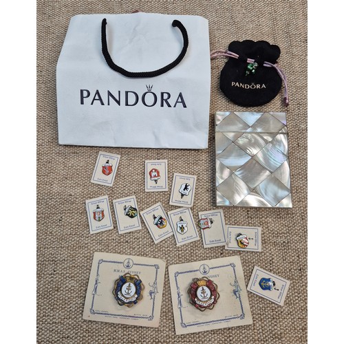 443 - A box of collectables including a mother of Pearl cigarette case, several silver enamelled badges et... 