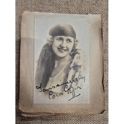 445 - A vintage autograph book with various signed photos etc.