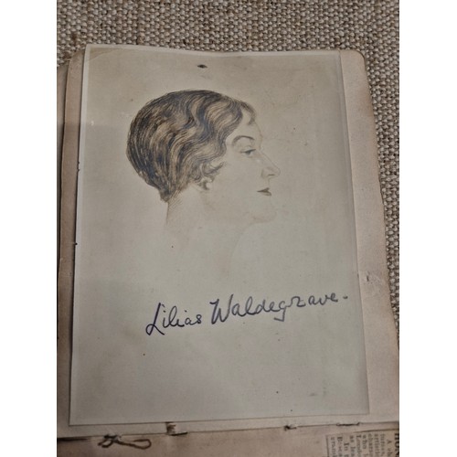 445 - A vintage autograph book with various signed photos etc.