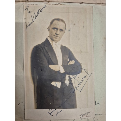 445 - A vintage autograph book with various signed photos etc.