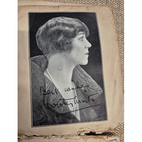 445 - A vintage autograph book with various signed photos etc.