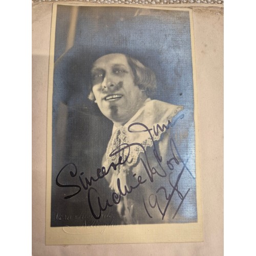 445 - A vintage autograph book with various signed photos etc.