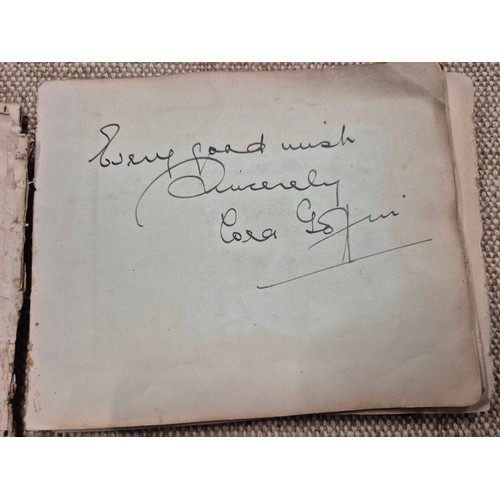 445 - A vintage autograph book with various signed photos etc.