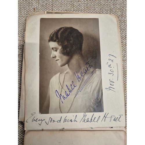 445 - A vintage autograph book with various signed photos etc.