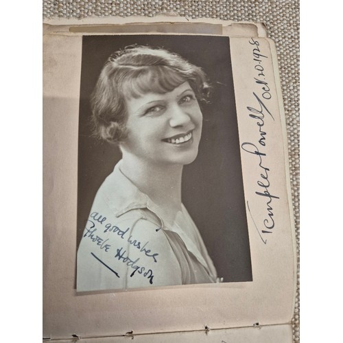 445 - A vintage autograph book with various signed photos etc.