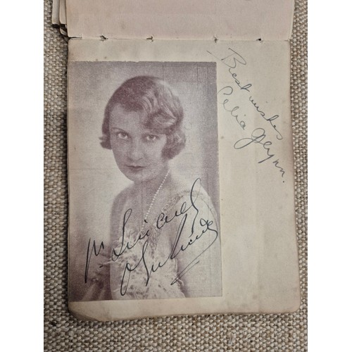 445 - A vintage autograph book with various signed photos etc.