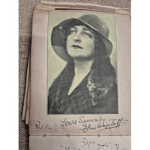 445 - A vintage autograph book with various signed photos etc.