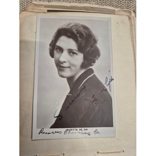 445 - A vintage autograph book with various signed photos etc.