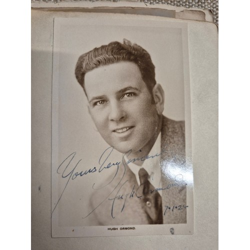 445 - A vintage autograph book with various signed photos etc.