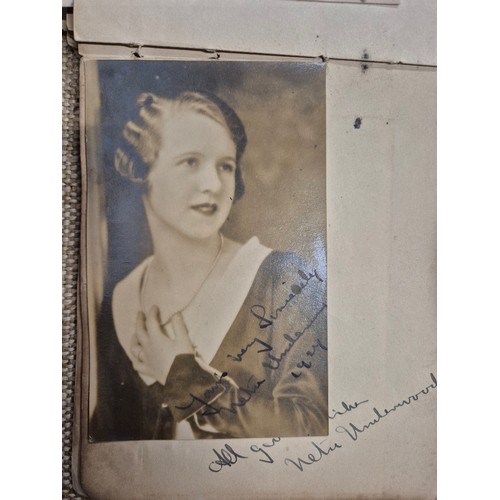 445 - A vintage autograph book with various signed photos etc.