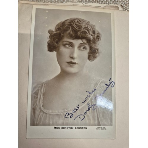 445 - A vintage autograph book with various signed photos etc.