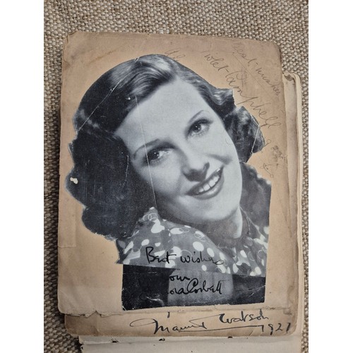 445 - A vintage autograph book with various signed photos etc.