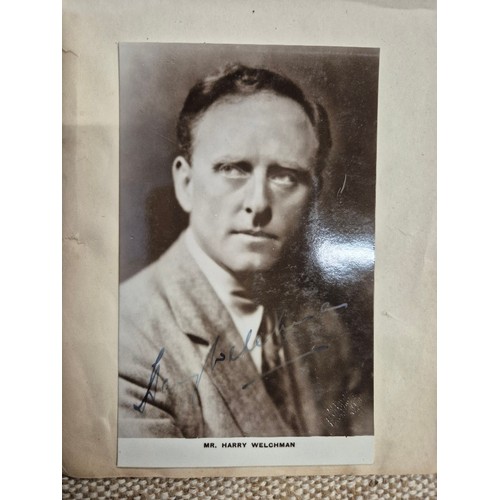 445 - A vintage autograph book with various signed photos etc.