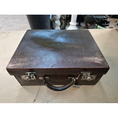 26 - A brown leather case by Drew & Sons, 'to the Royal Family', and a small Gladstone bag