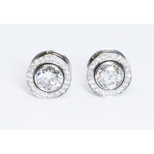 419G - BOODLES, a pair of diamond cluster earrings, the central round brilliant cut stones weighing approxi... 