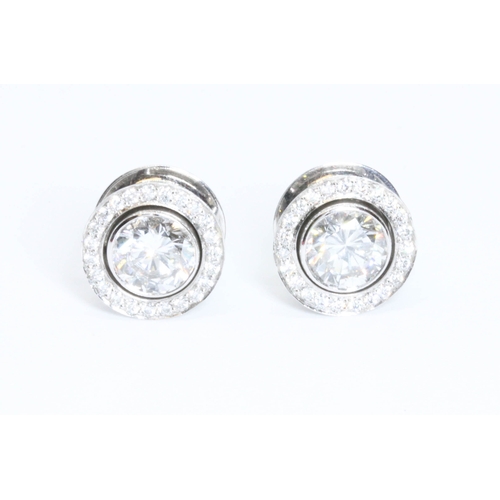 419G - BOODLES, a pair of diamond cluster earrings, the central round brilliant cut stones weighing approxi... 
