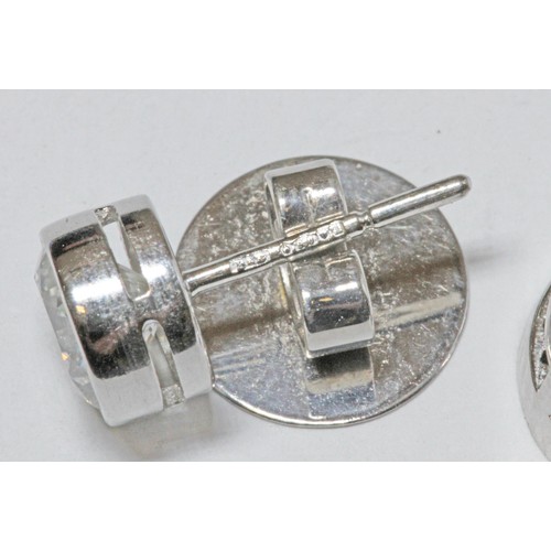 419G - BOODLES, a pair of diamond cluster earrings, the central round brilliant cut stones weighing approxi... 