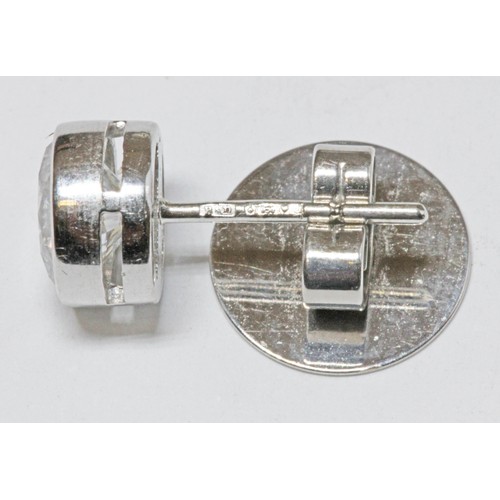 419G - BOODLES, a pair of diamond cluster earrings, the central round brilliant cut stones weighing approxi... 