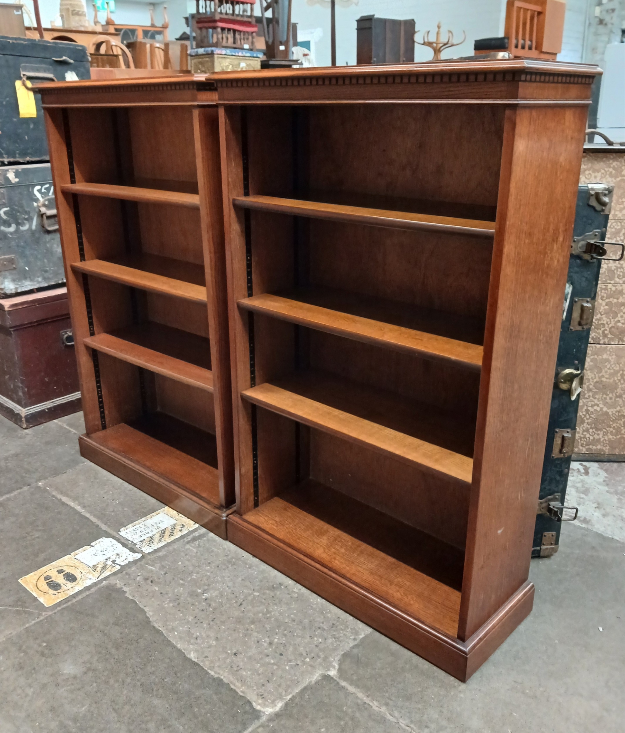 A pair of reproduction open oak veneered bookcases with adjustable ...