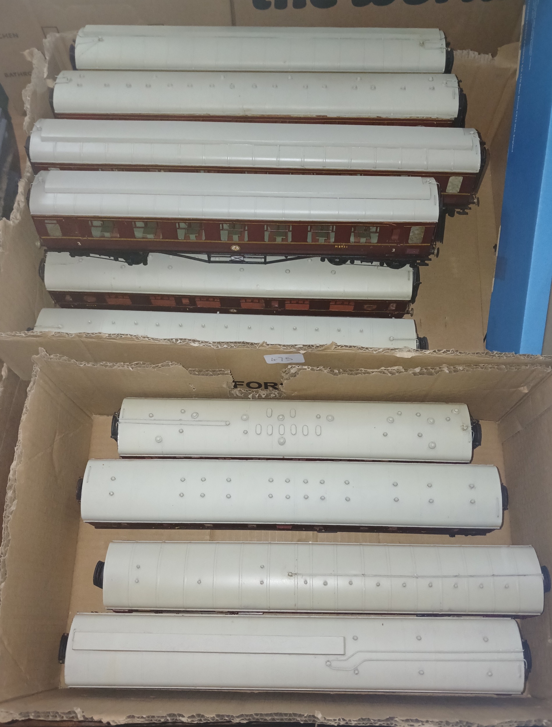 Two boxes of assorted 0 gauge model railway kit-built coaches.