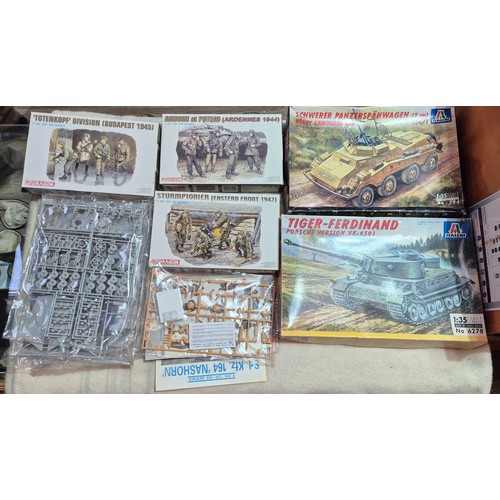 A box of assorted military model kits to include tanks & soldiers.