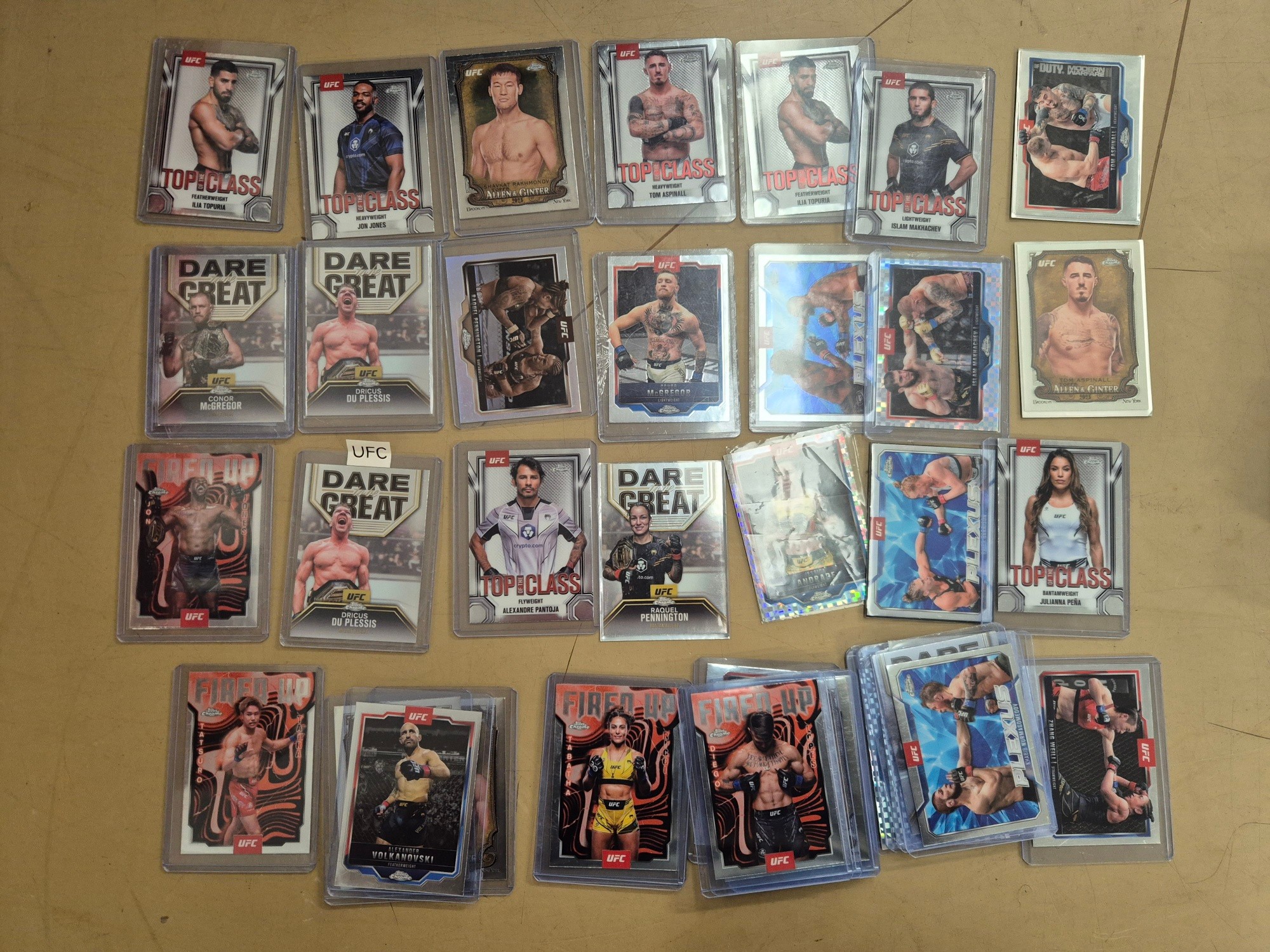 A box of Topps Trading cards including football players and UFC