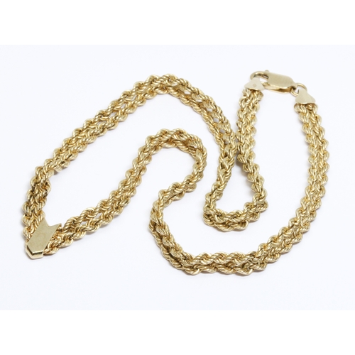 13 - A 9ct gold double rope twist choker necklace, convention marks, length 42cm, weight 10g.