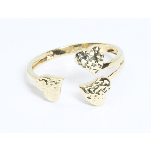 32 - A hallmarked 9ct gold formed as three hearts, weight 1.5g, size S.