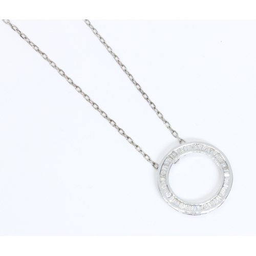 34 - A hallmarked 9ct white gold diamond pendant of circular form, diameter 21mm, suspended on 54cm chain... 