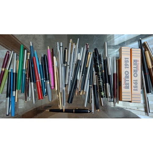 A group of assorted pens to include Parkers etc.