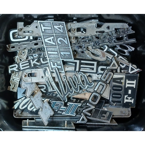 186 - A box of assorted classic car badges.