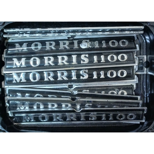 187 - A box of assorted classic car badges.