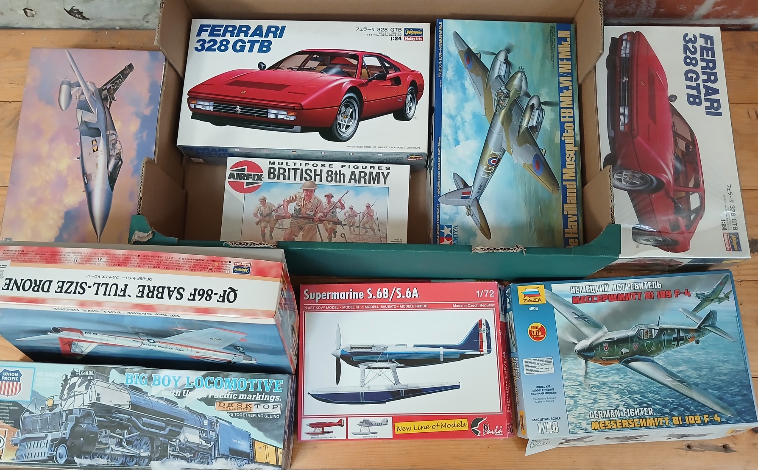 A box of assorted unbuilt model kits.