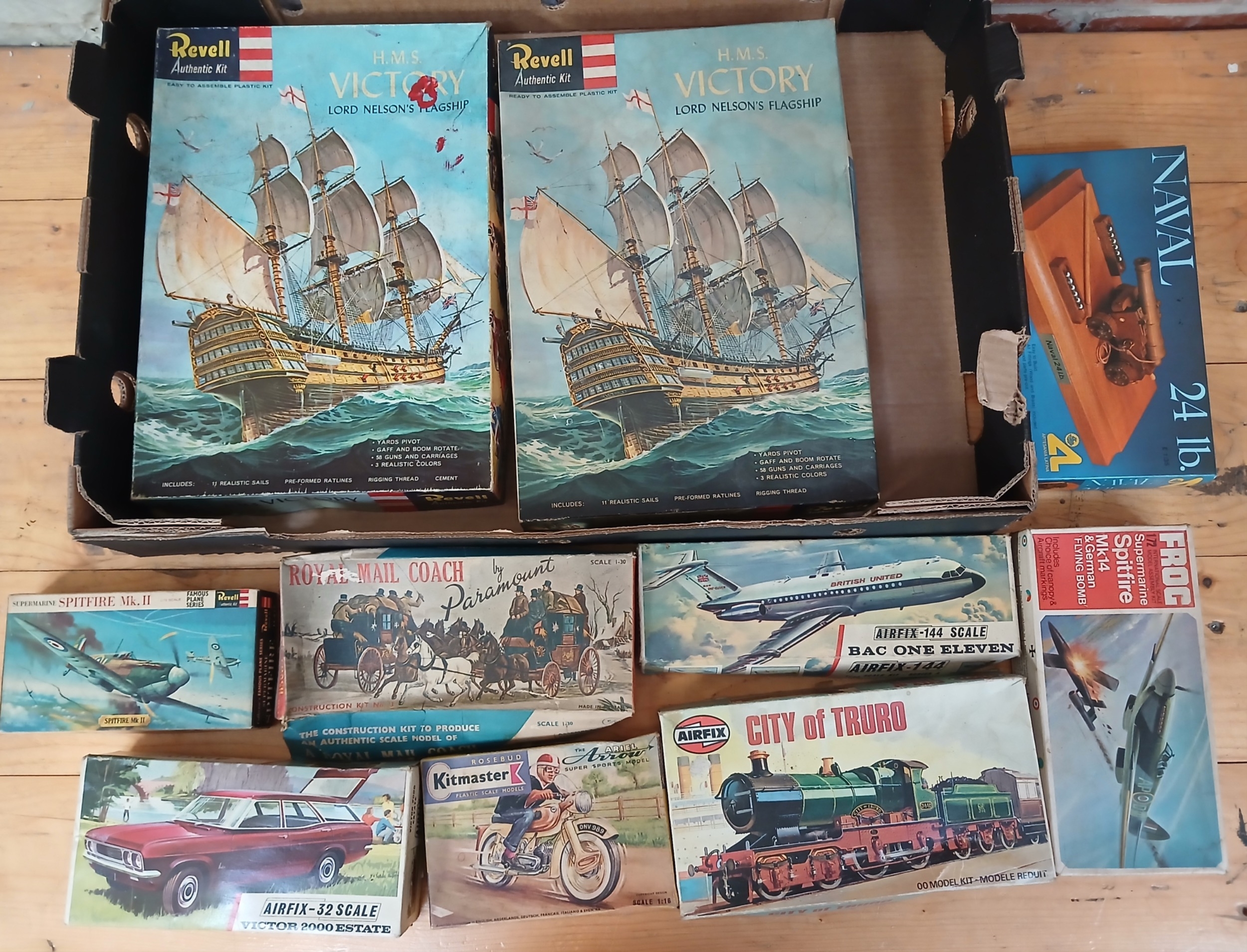 A box of assorted unbuilt model kits.