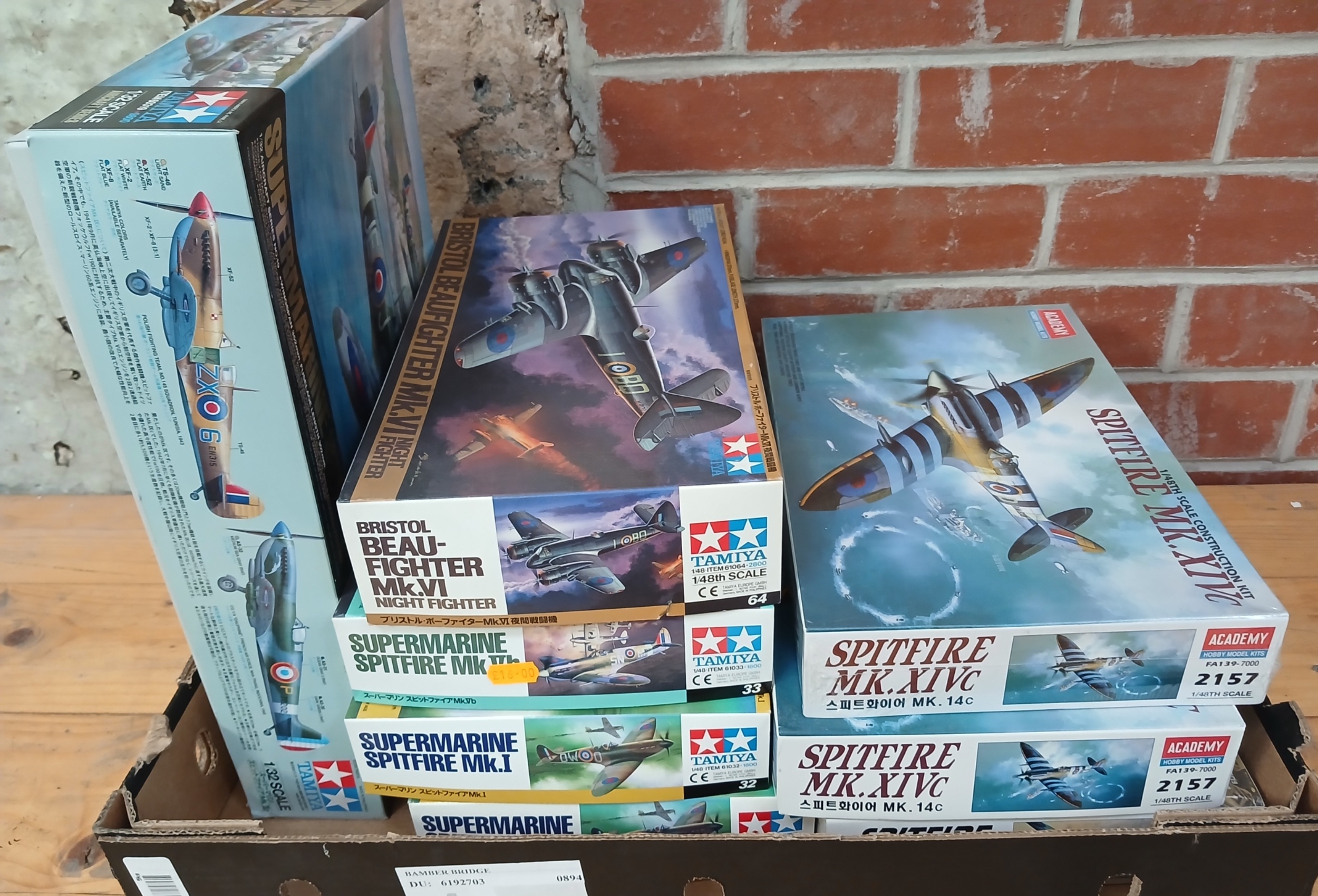 A box of assorted unbuilt model kits.