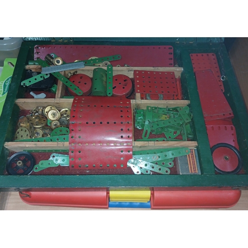 516 - A wooden box containing circa 1940s green and red Meccano parts together with a modern Meccano set.