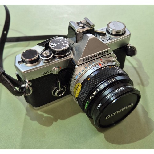 An Olympus OM2 35mm camera and an Canon EOS 5000.