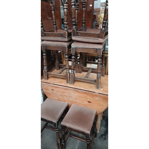 695 - A pine drop leaf table and a set of six stools.