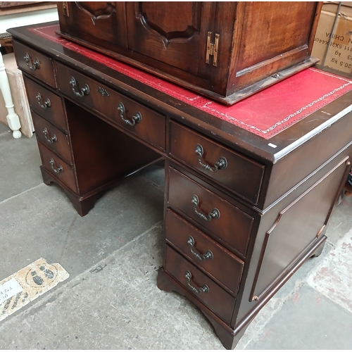 702 - A reproduction pedestal desk.
