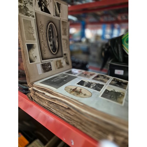 163 - A vintage album containing postcards, photographs and press cuttings c1920s