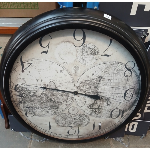 142 - A large battery operated wall clock - diameter appx 3 ft. Background image of the world