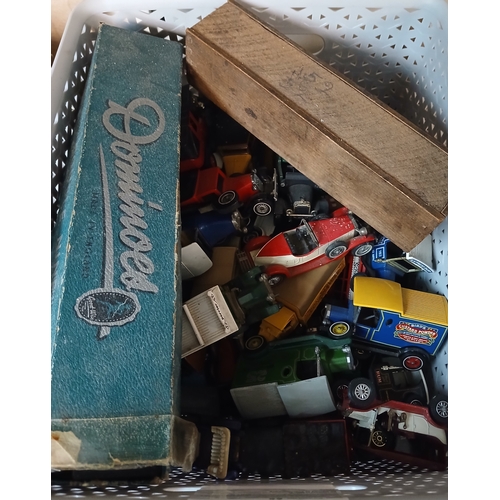 402 - A box containing playworn cars, dominos (sixes and nines) etc