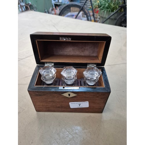 7 - A hinged wooden scent casket containing a set of three perfume bottles