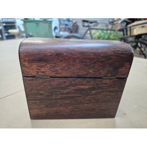 7 - A hinged wooden scent casket containing a set of three perfume bottles