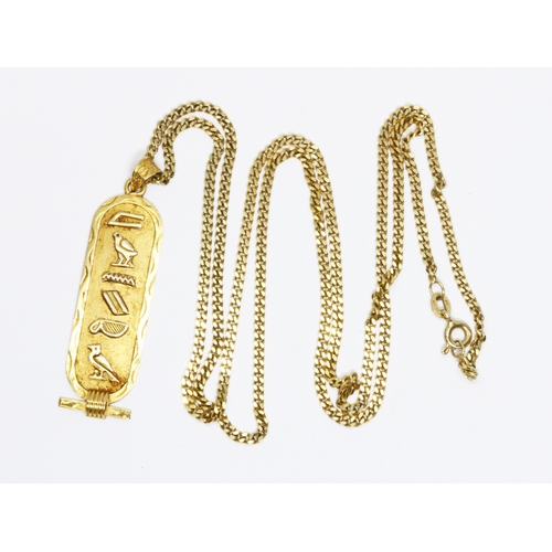 53 - An Egyptian ingot pendant, indistinct marks, weight 3.6g, length 43mm, suspended on 60cm curb chain,... 